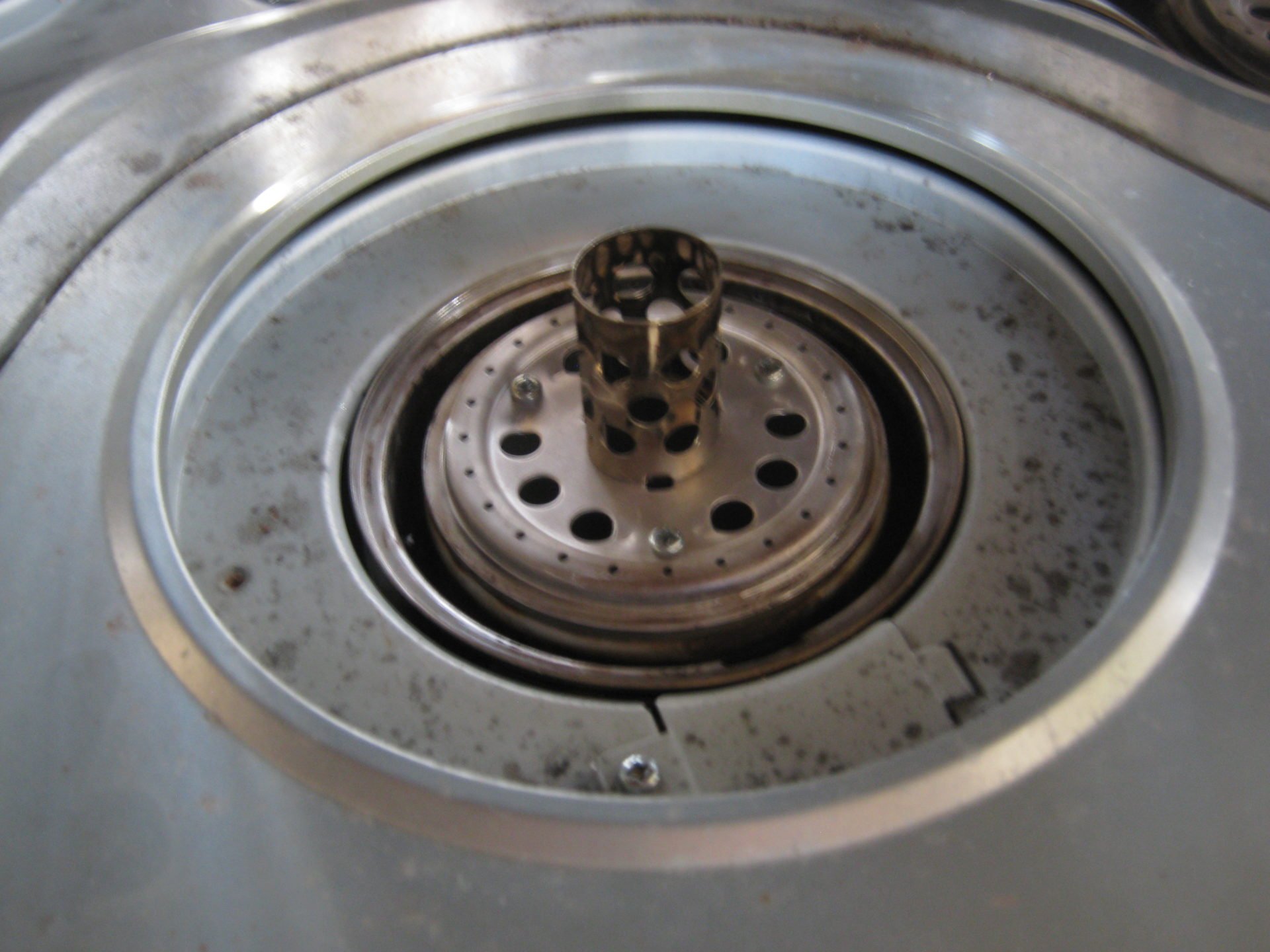コロナ 石油ストーブ の 芯案内筒 案内筒リング の タール を 雑巾で拭き除去 掃除します。 固くこびり付いてとれないタールは マイナスドライバーで削り取ります。